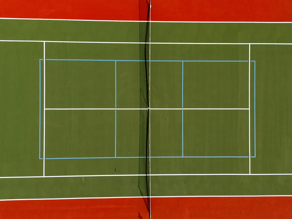 Freshly painted red, green, and white tennis and pickleball hybrid court