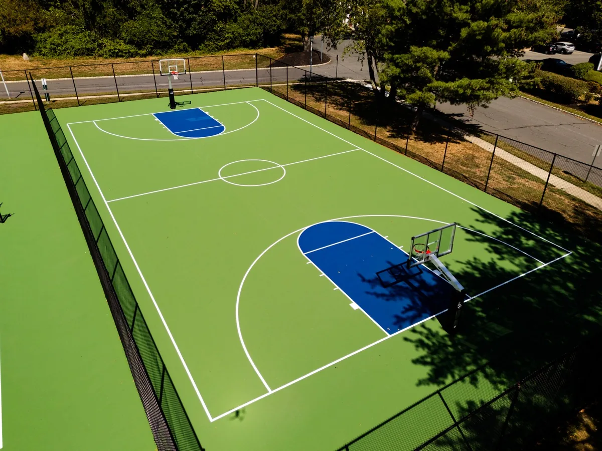 Vibrant basketball court installed by America Sports Construction